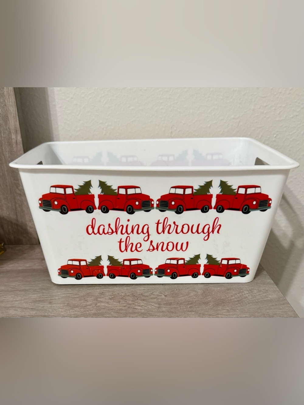 A rectangular white plastic container (basket) with cutout handles.